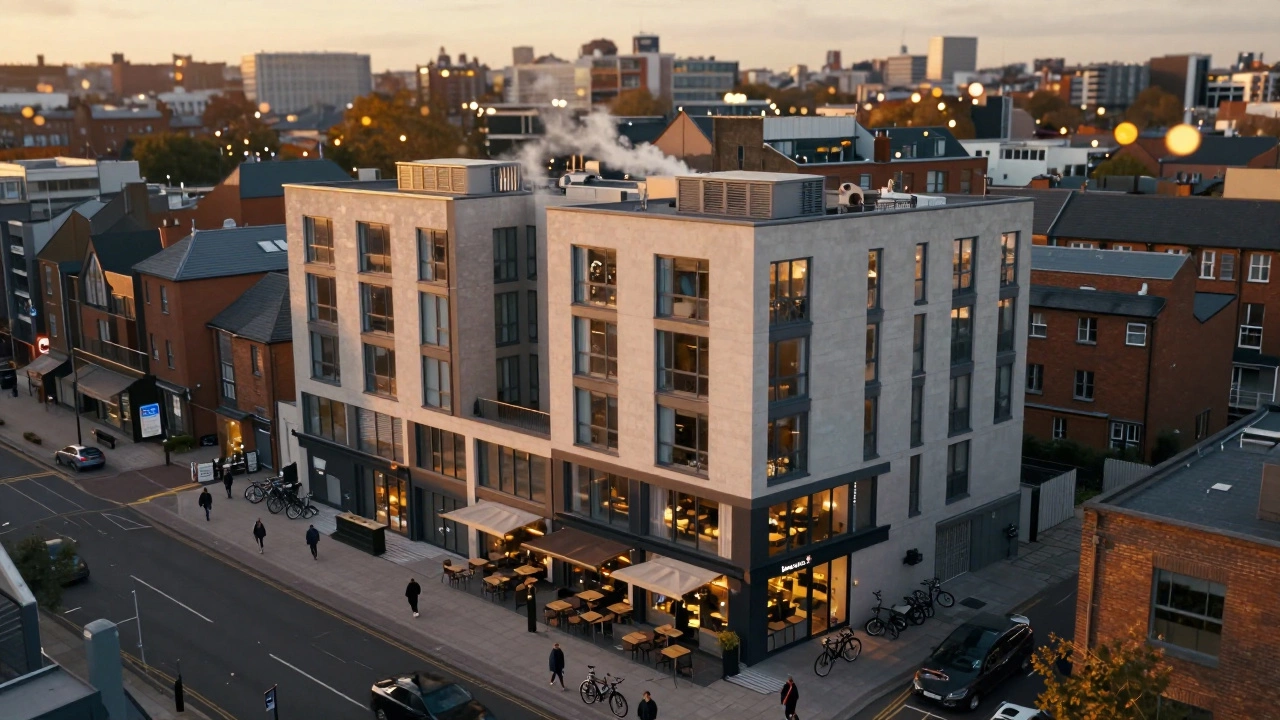 Aerial view of a mixed-use urban building with retail on ground floor and apartments above at sunset.